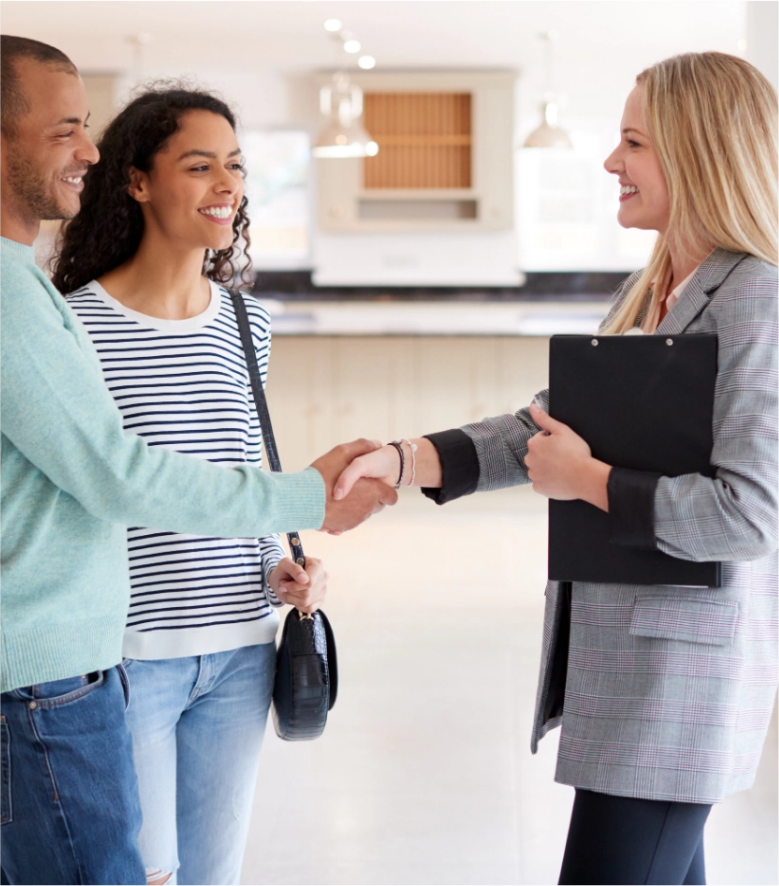 Real estate agent meeting clients while managing business with CRM